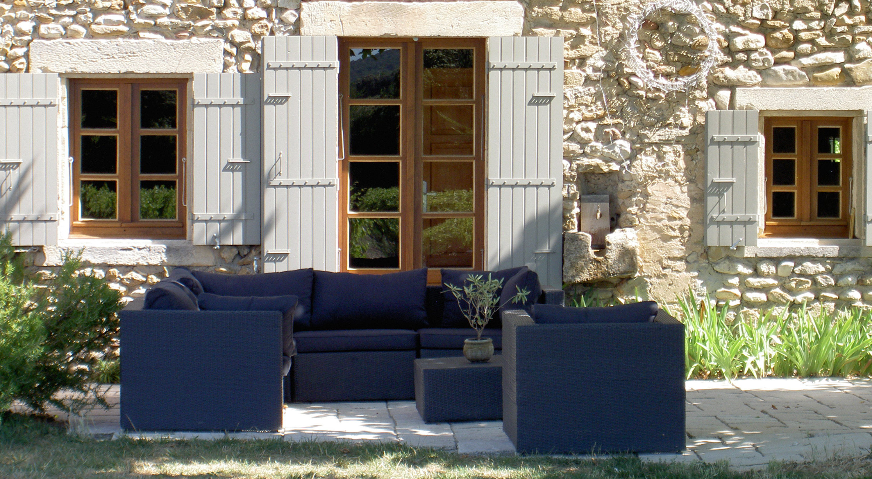 Comfy garden furniture in the shade of the plane tree