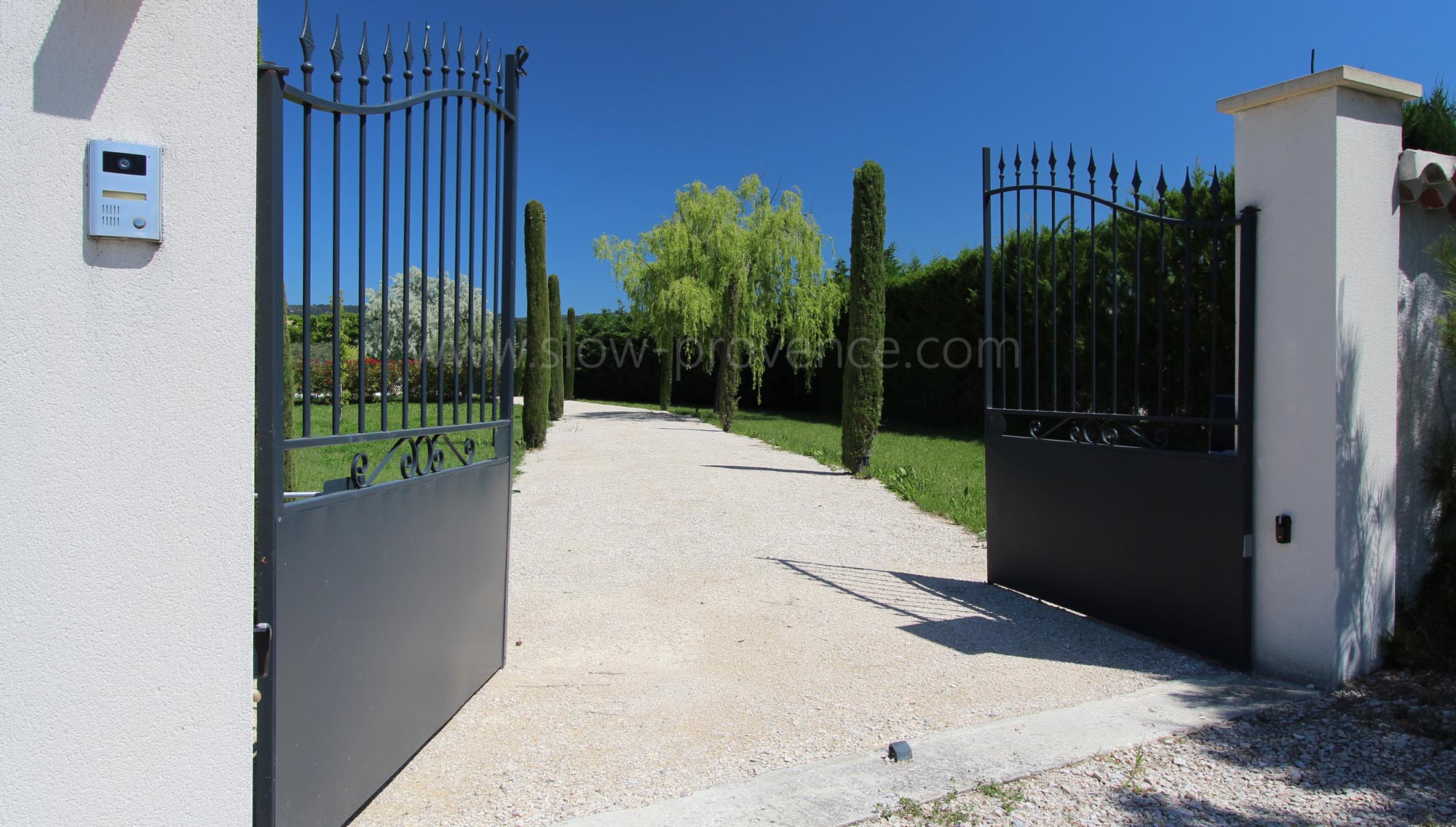 Electric gate and cypresses