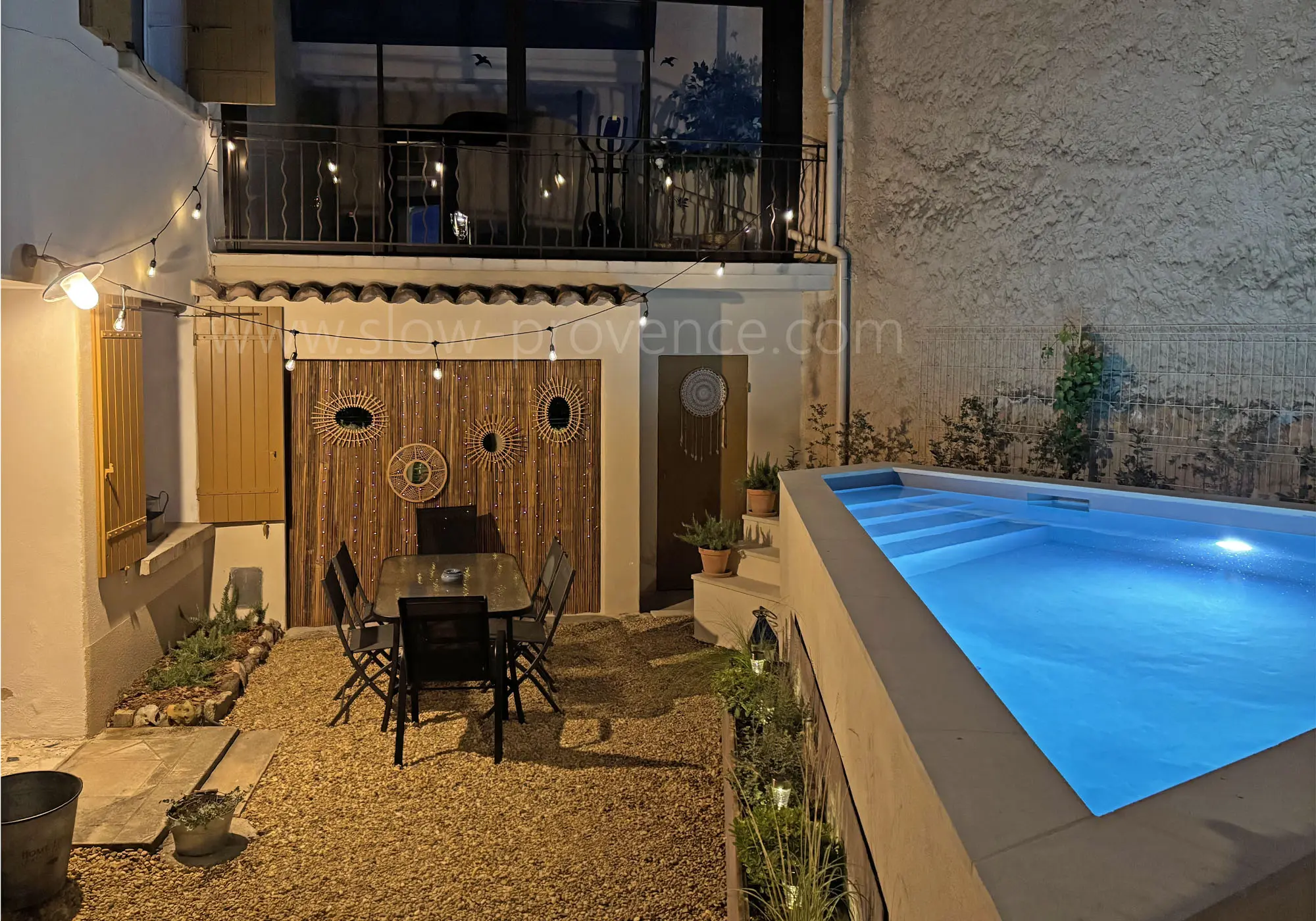 Courtyard and swimming pool lit up at night
