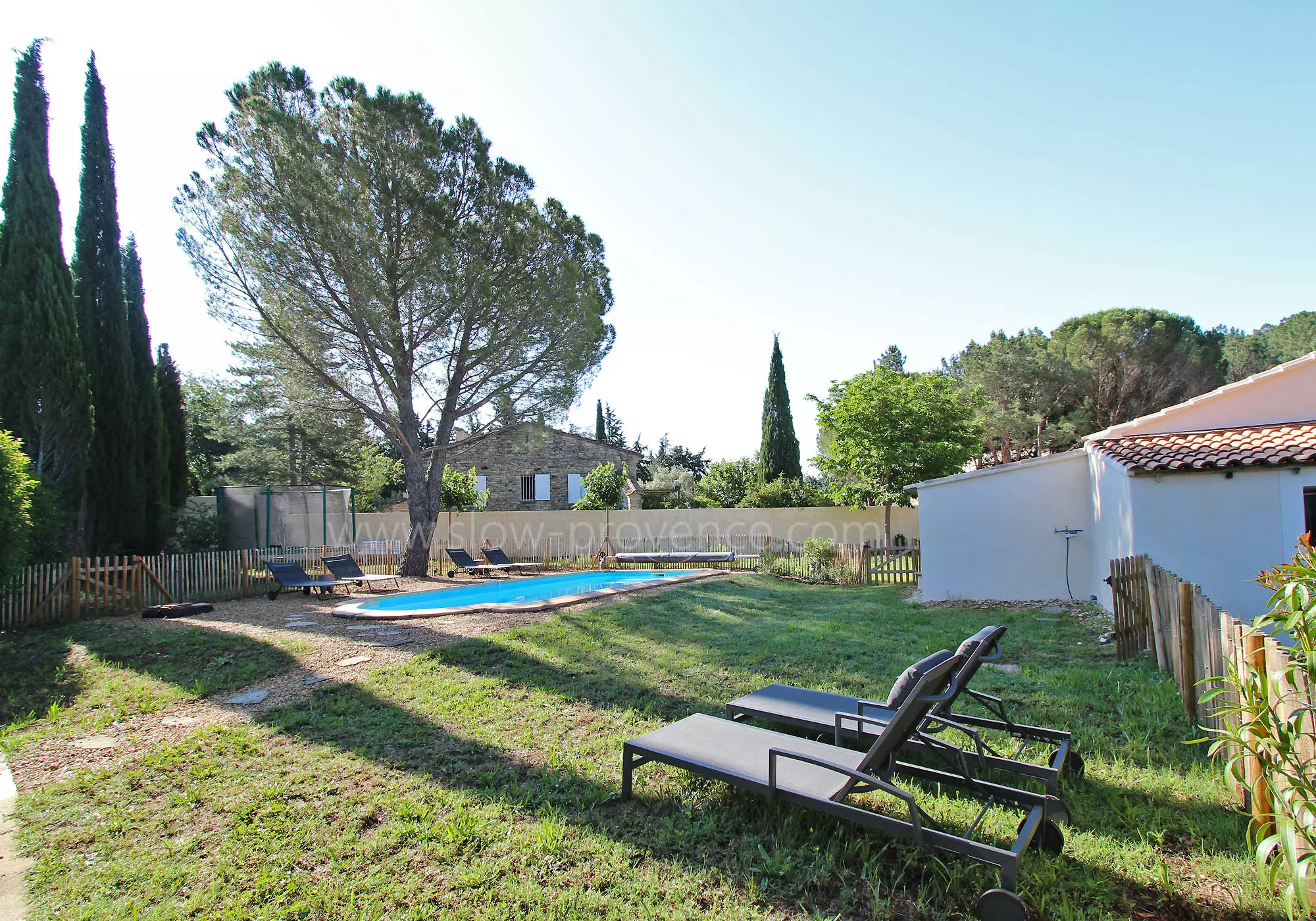 A large fenced garden and a heated pool