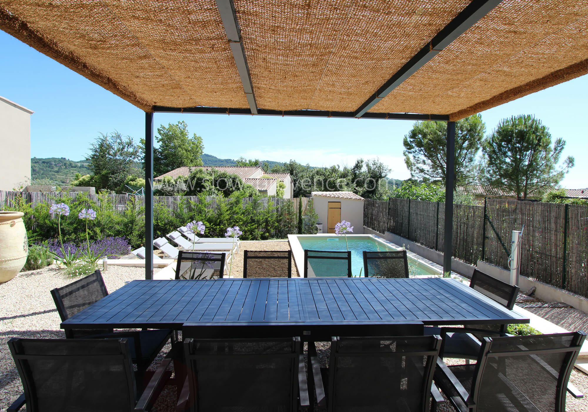 Shaded terrace with pool view